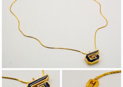 Elegant gold chain necklace with a unique rectangular pendant and detailed clasp.
