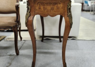 Ornate wooden side table with curved legs and intricate inlay design.