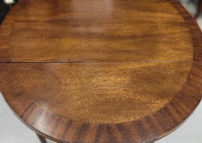 Close-up of a wooden table with a polished finish and rounded edges.
