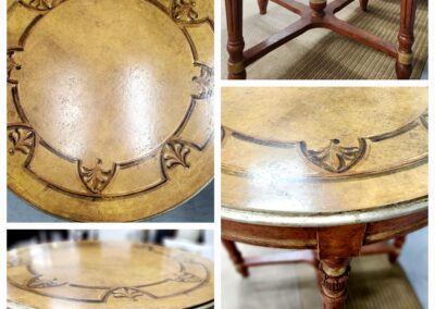 Antique wooden table with intricate carvings and a round top.