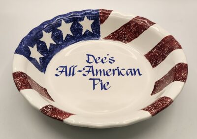 A patriotic pie dish with American flag design and text.