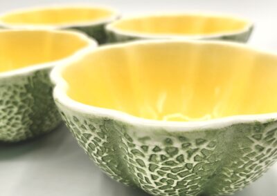 Hollowed-out cantaloupe halves with bright yellow interiors.