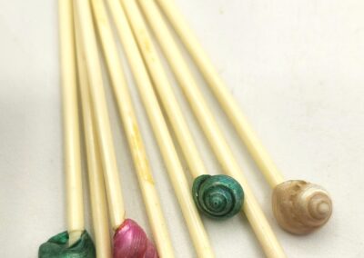 Colorful marbled lollipops on wooden sticks arranged diagonally.