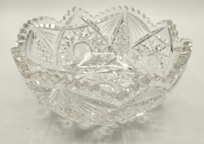 Intricately cut glass bowl with a starburst pattern.