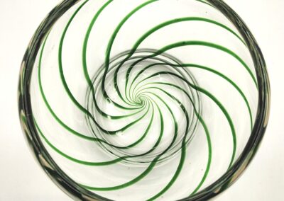 Abstract circular design with green spirals on a white background.