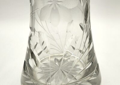 A clear glass with intricate cut designs and a flared base.