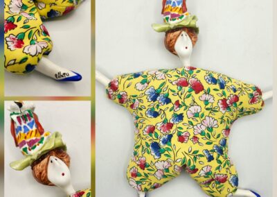 A colorful clown doll with a floral outfit and a playful hat.