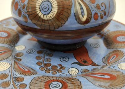 Close-up of a decorative ceramic bowl and plate with intricate floral patterns.