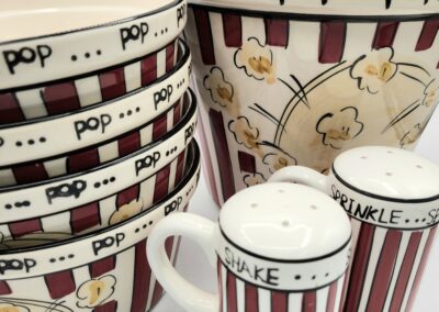 Popcorn-themed popcorn containers and mugs with vintage designs.