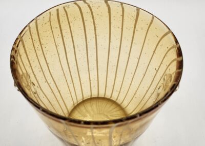 A vintage amber glass bowl with vertical ribbed lines.