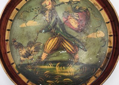 Vintage painted tray featuring a man in colorful attire walking with a bird and ship in the background.