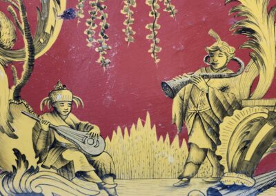 Two musicians performing on a vibrant red backdrop with ornate details.