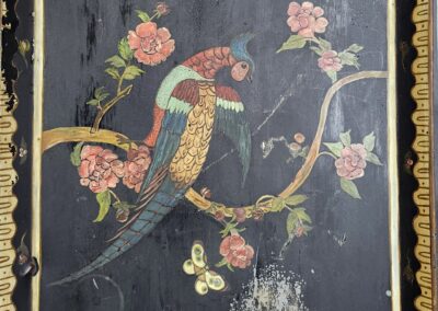 Vintage painting of two colorful birds perched on a blossoming branch.