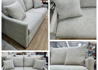 Modern gray fabric sofa with plush cushions and clean lines.
