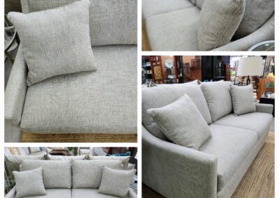 Modern gray fabric sofa with cushioned seats and pillows.