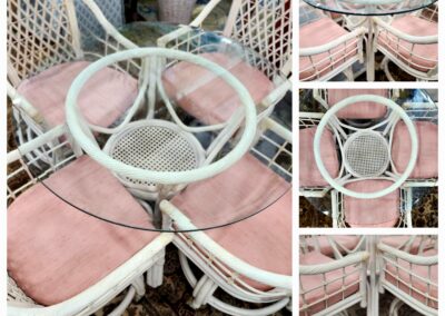 White wicker dining set with pink cushions and glass-top table.