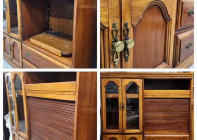 Detailed wooden cabinet with multiple compartments and decorative elements.