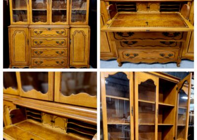 Elegant wooden secretary desk with glass cabinets and intricate carvings.