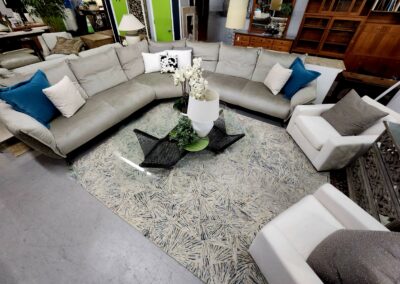Spacious living room with sectional sofa and modern glass coffee table.
