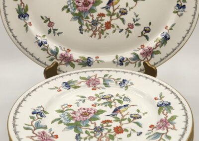 Decorative porcelain plates with floral and bird motifs.
