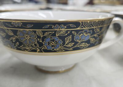 Close-up of a decorative ceramic bowl with floral patterns and gold accents.