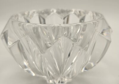 Clear glass bowl with geometric patterns and faceted edges.
