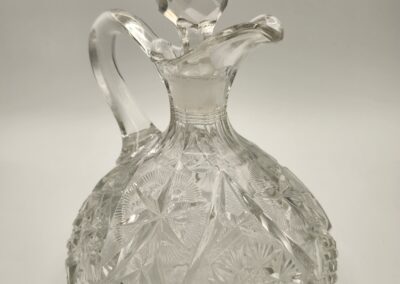Elegant vintage glass decanter with intricate cut patterns.