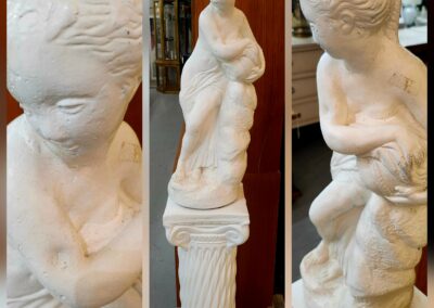 A detailed marble statue of a woman in classical style shown from three angles.