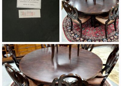 Antique round wooden dining table with matching chairs on a patterned rug.