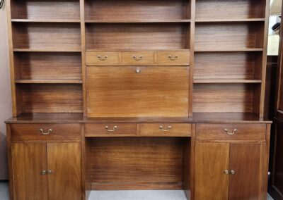 Vintage wooden desk with shelves and cabinets.