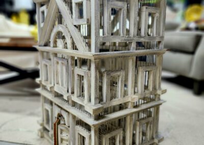 Intricate three-story architectural model made from natural materials.