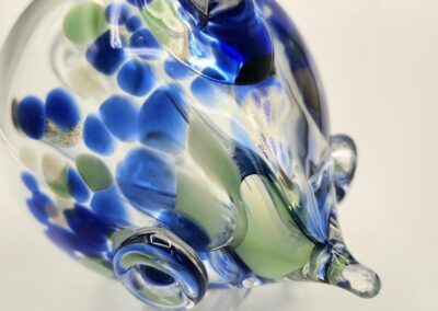 Close-up of a glass fish with blue and green spots.