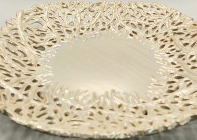 Intricately designed lace doily with a delicate floral pattern.