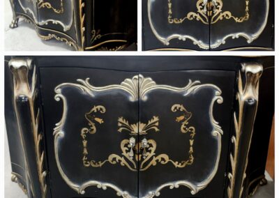 Elegant black and gold vintage cabinet with ornate floral designs.