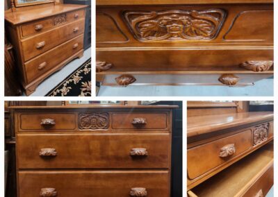 Vintage wooden dresser with intricate carvings and multiple drawers.