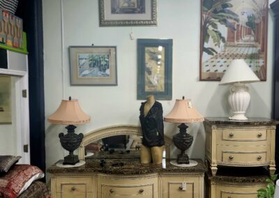 A cozy living room corner with vintage lamps and framed artwork.