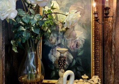 Elegant floral arrangement and decorative swan on a vintage table.