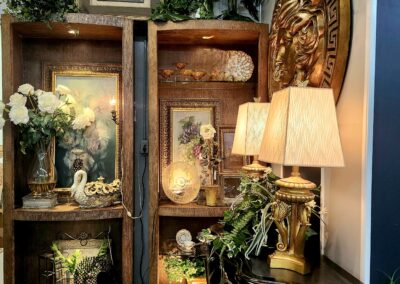 Elegant wooden shelves decorated with clocks, flowers, and a lamp in a cozy corner.