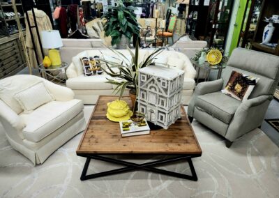 Cozy living room with neutral sofas and a wooden coffee table centerpiece.