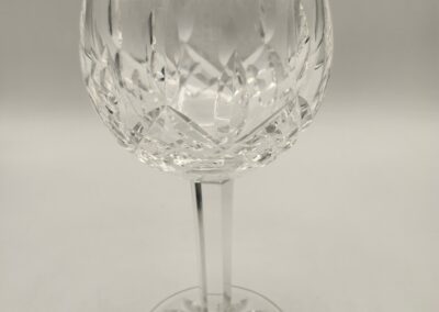 Elegant crystal wine glass with intricate cut patterns.