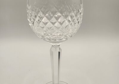 Elegant crystal wine glass with intricate diamond-cut design.