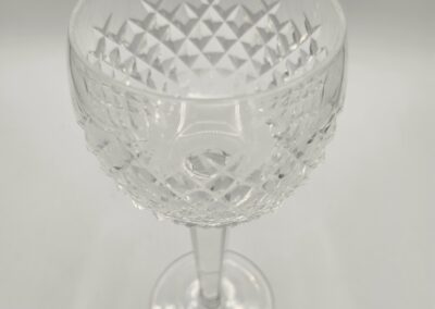 Clear crystal wine glass with intricate cut designs.
