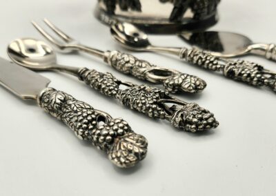 Ornate silverware with detailed floral handles.