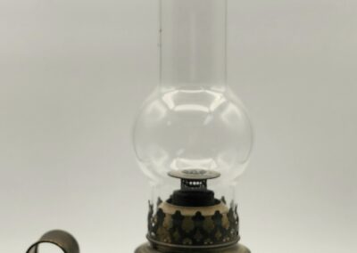 Vintage oil lamp with a glass chimney and brass base.