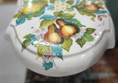 Decorative ceramic toilet seat lid with fruit design.