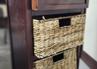 Wooden furniture with woven wicker baskets as storage drawers.