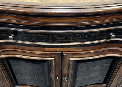 Elegant wooden cabinet with curved edges and detailed glass doors.