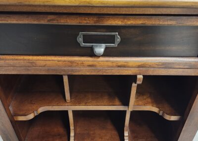 Wooden vintage cabinet with open shelves and a single drawer.