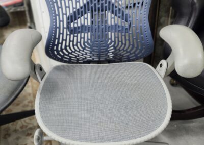 Ergonomic office chair with mesh back and padded armrests.