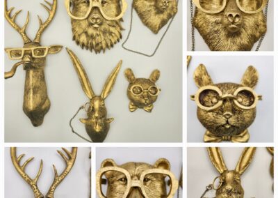 Gold animal head wall mounts including a deer, owl, fox, and bear.